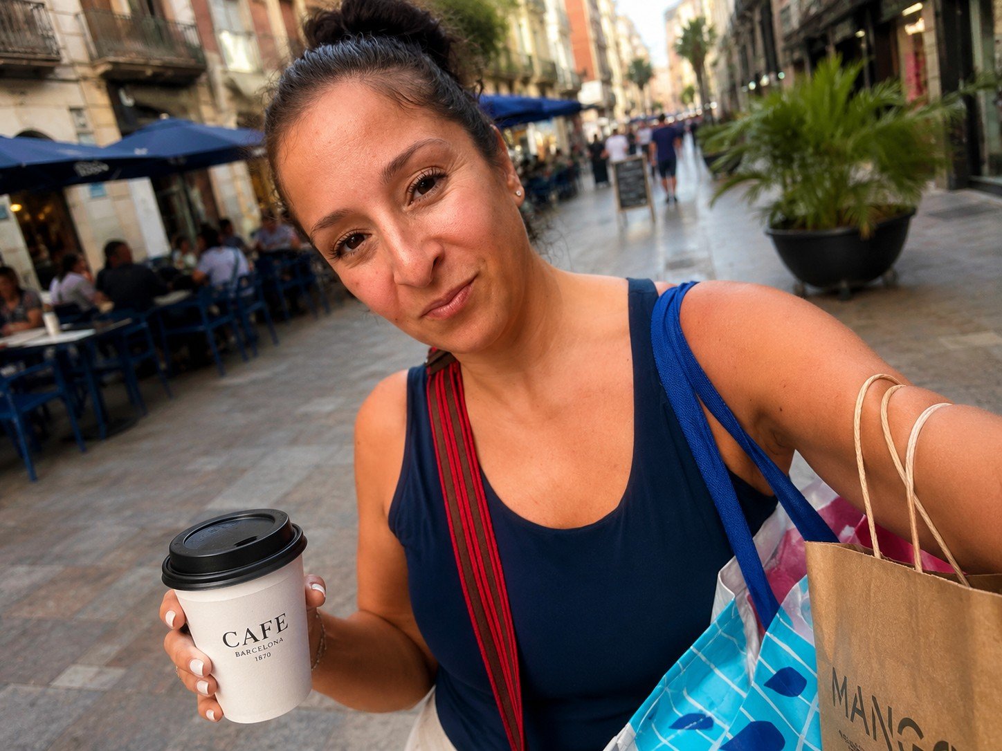 Michelle traveling with coffee and shopping bags