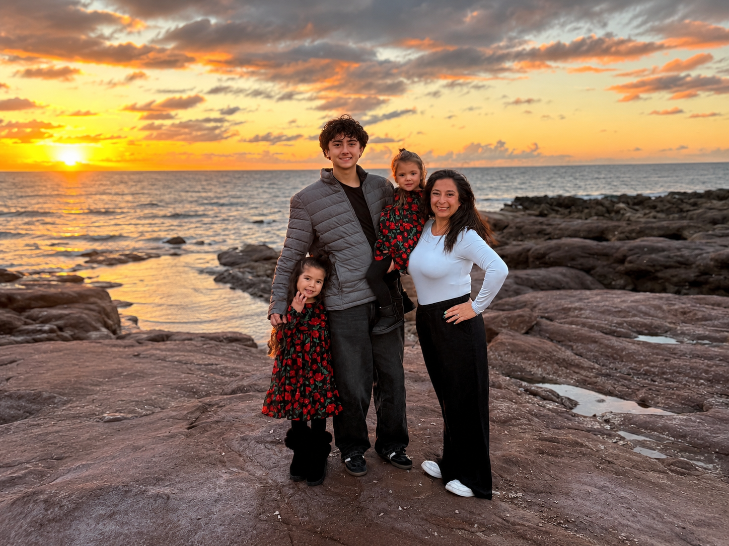 Michelle and her children at the beach at sunset